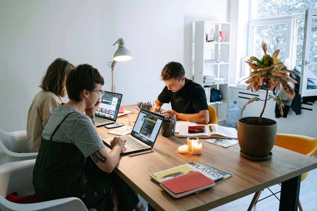 Team members working together on laptops in a modern coworking space for startups.