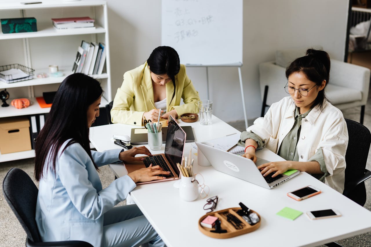 Women deeply engaged while working on a laptop, illustrating the immersive focus and productivity that characterize being in flow