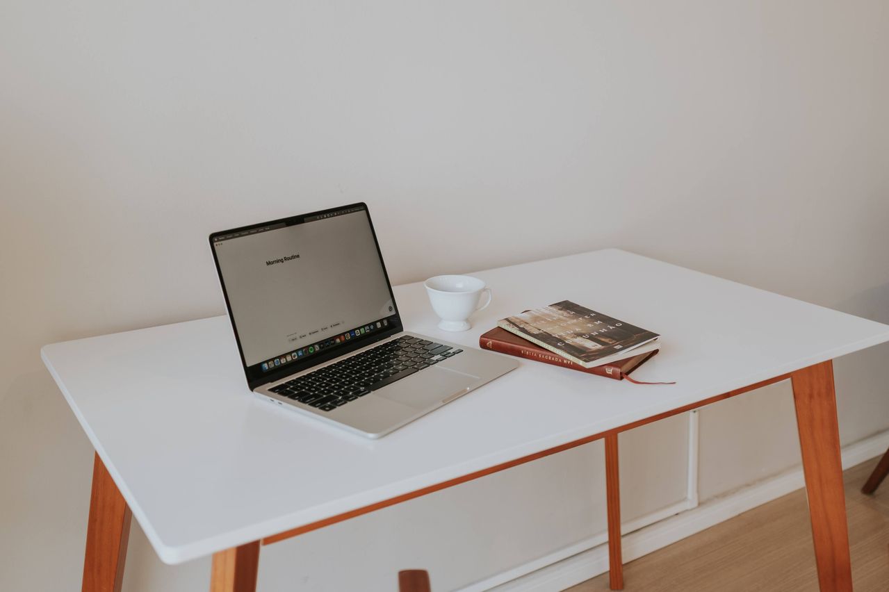 Modern workspace with laptop, books, and stylish desk setup for productivity, remote work, and home office inspiration