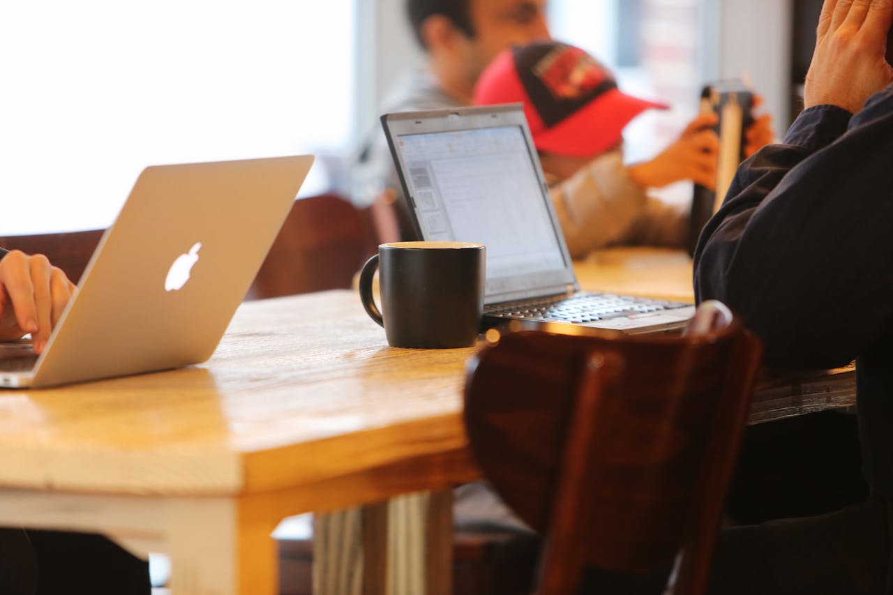 Team members working together on laptops in a modern coworking space for startups.