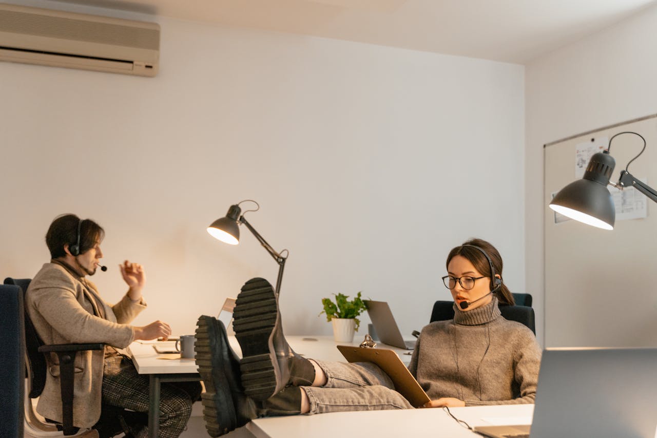 Woman reviewing notes on a clipboard, concentrating during a focused work session.