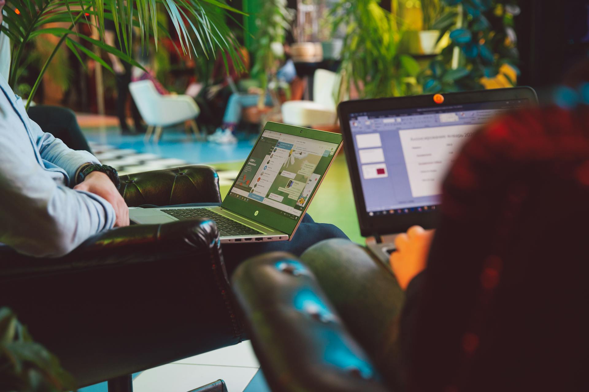Person holding two laptops while working remotely, representing flexible freelance work and mobile productivity in 2026.
