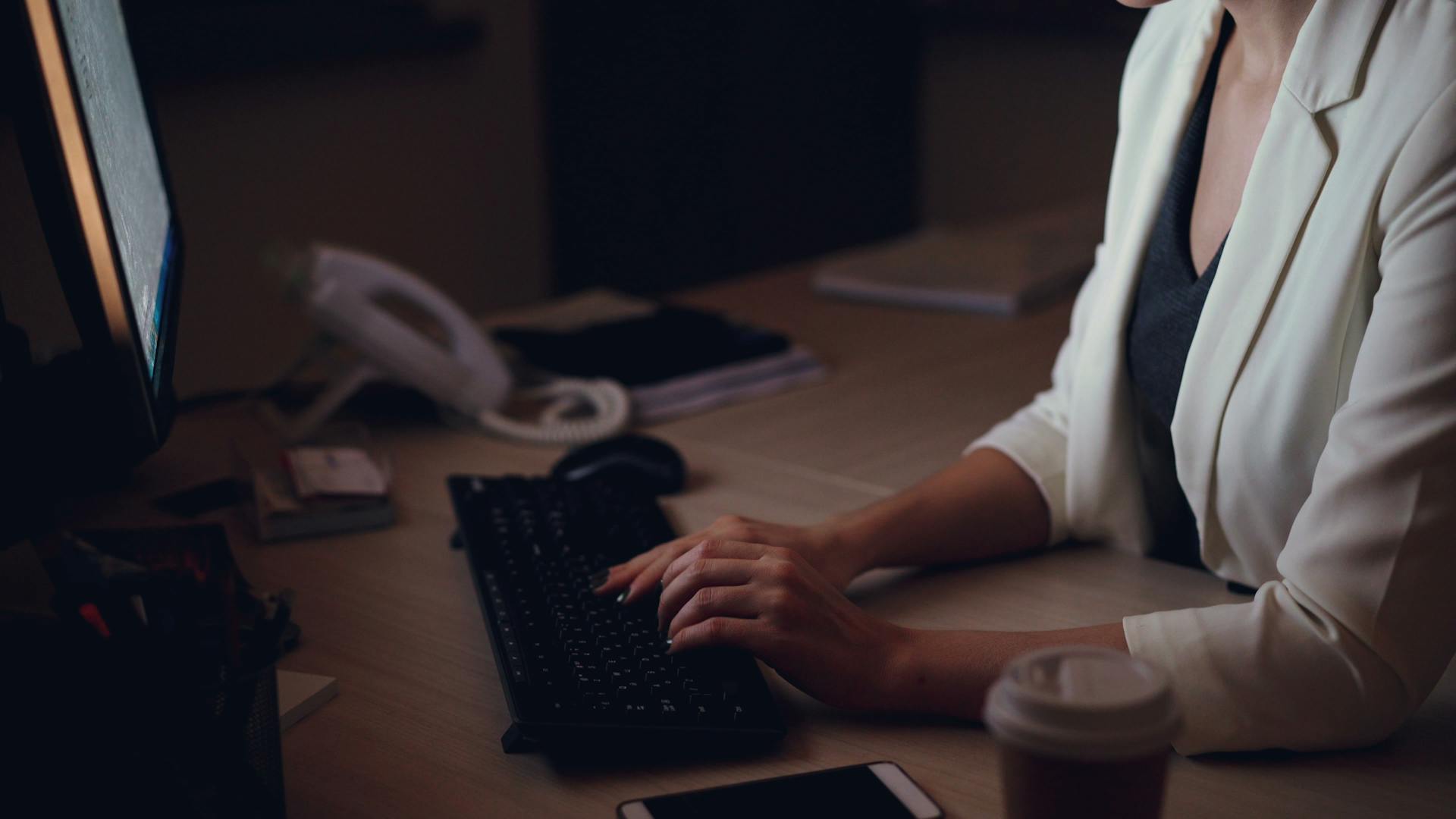 Woman working intently late at night on her office computer, capturing the state of complete absorption and timeless focus known as flow state.