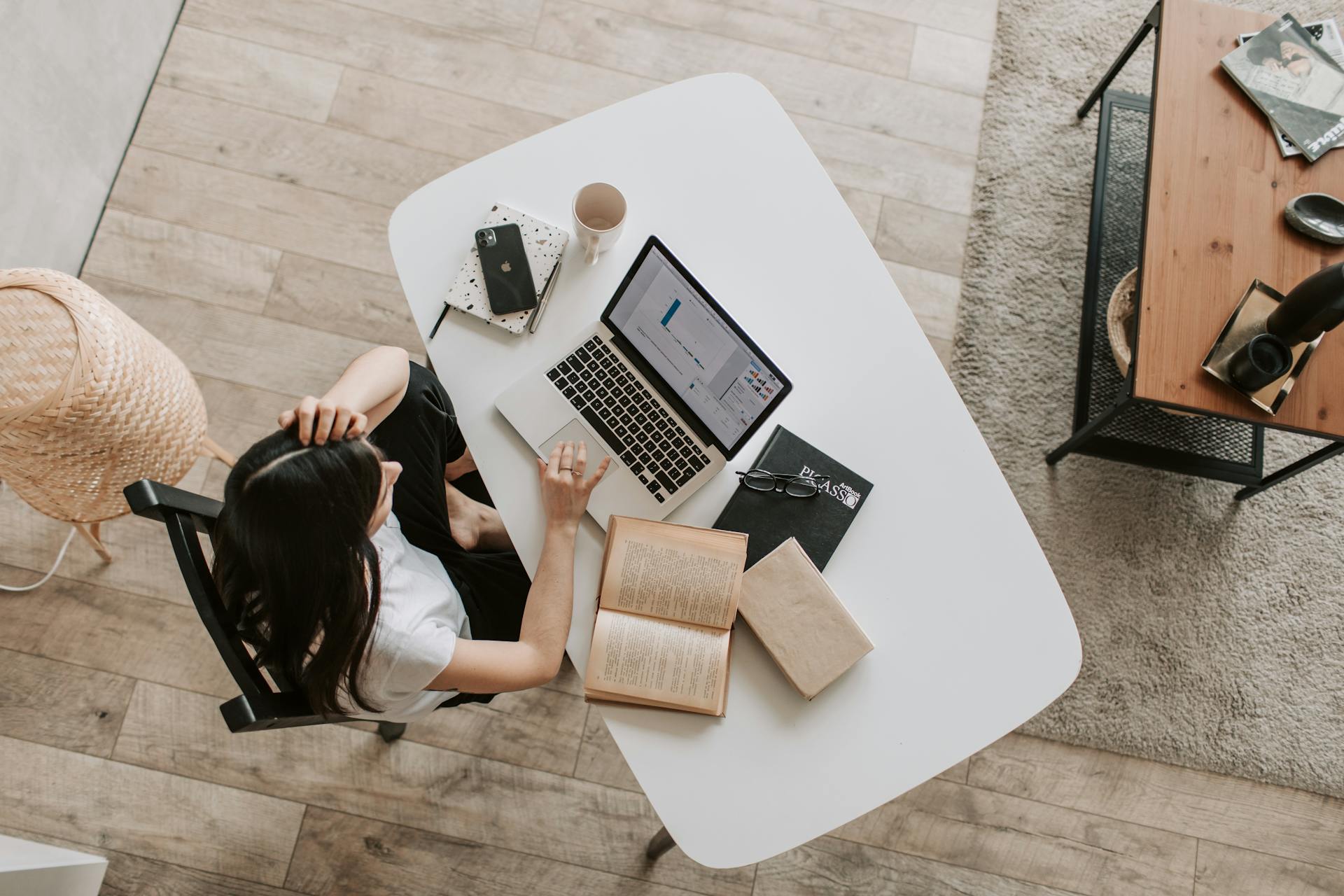 Woman working alone on laptop in a modern workspace.