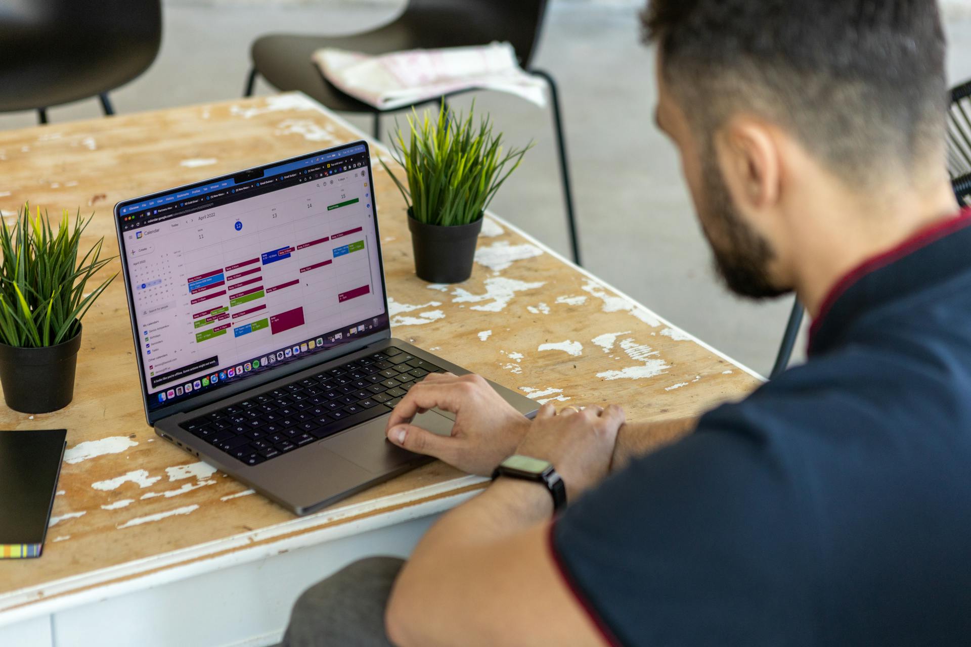 A man focused on his laptop, applying the 80/20 rule - prioritizing the vital few tasks that drive the majority of results in productivity.